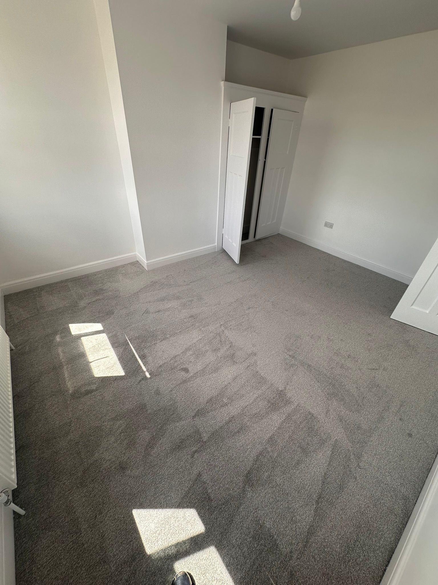 Clean grey twist-pile bedroom carpet in a rental property