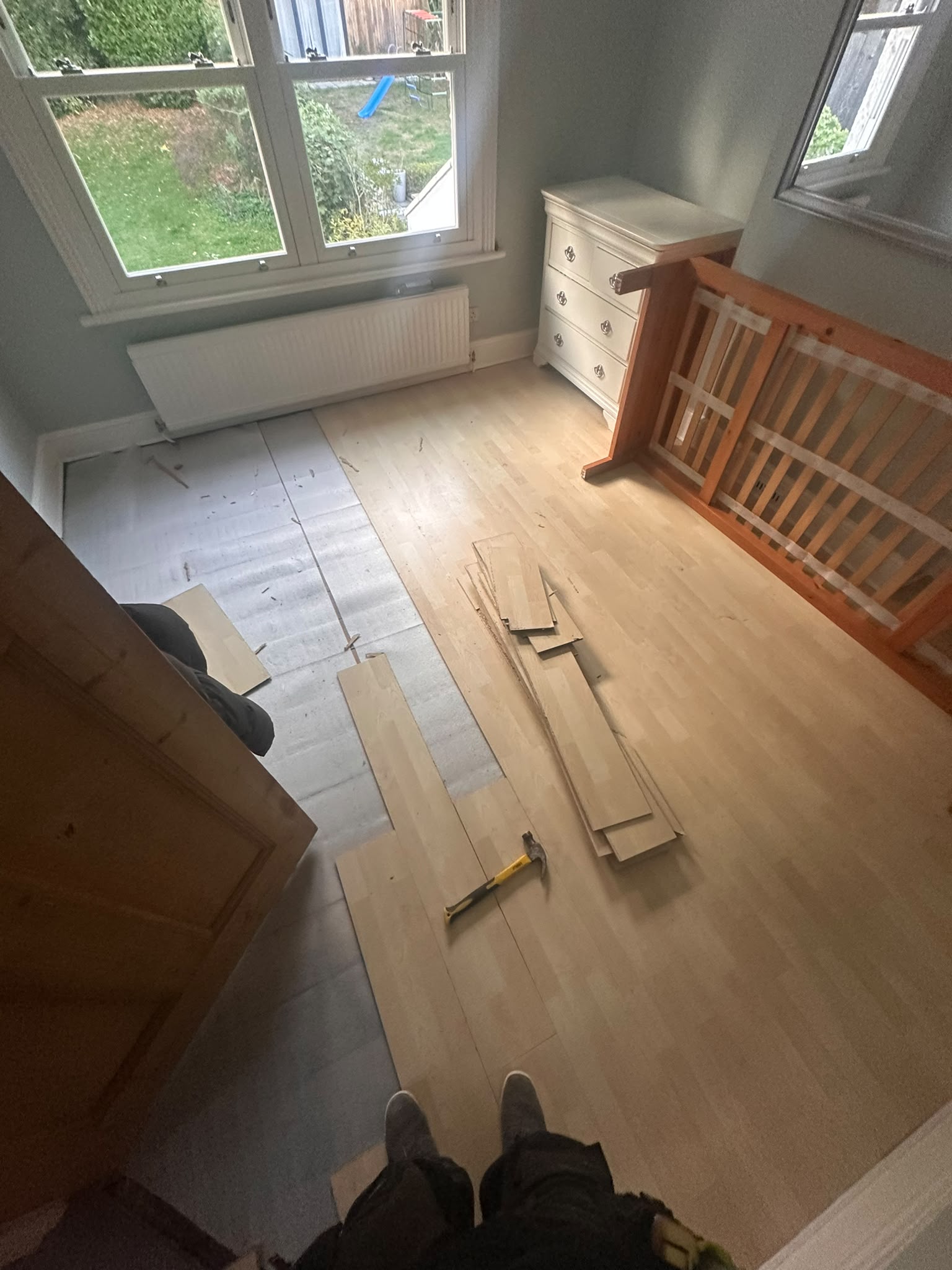Bedroom with laminate flooring being uplifted before new carpet — South Croydon