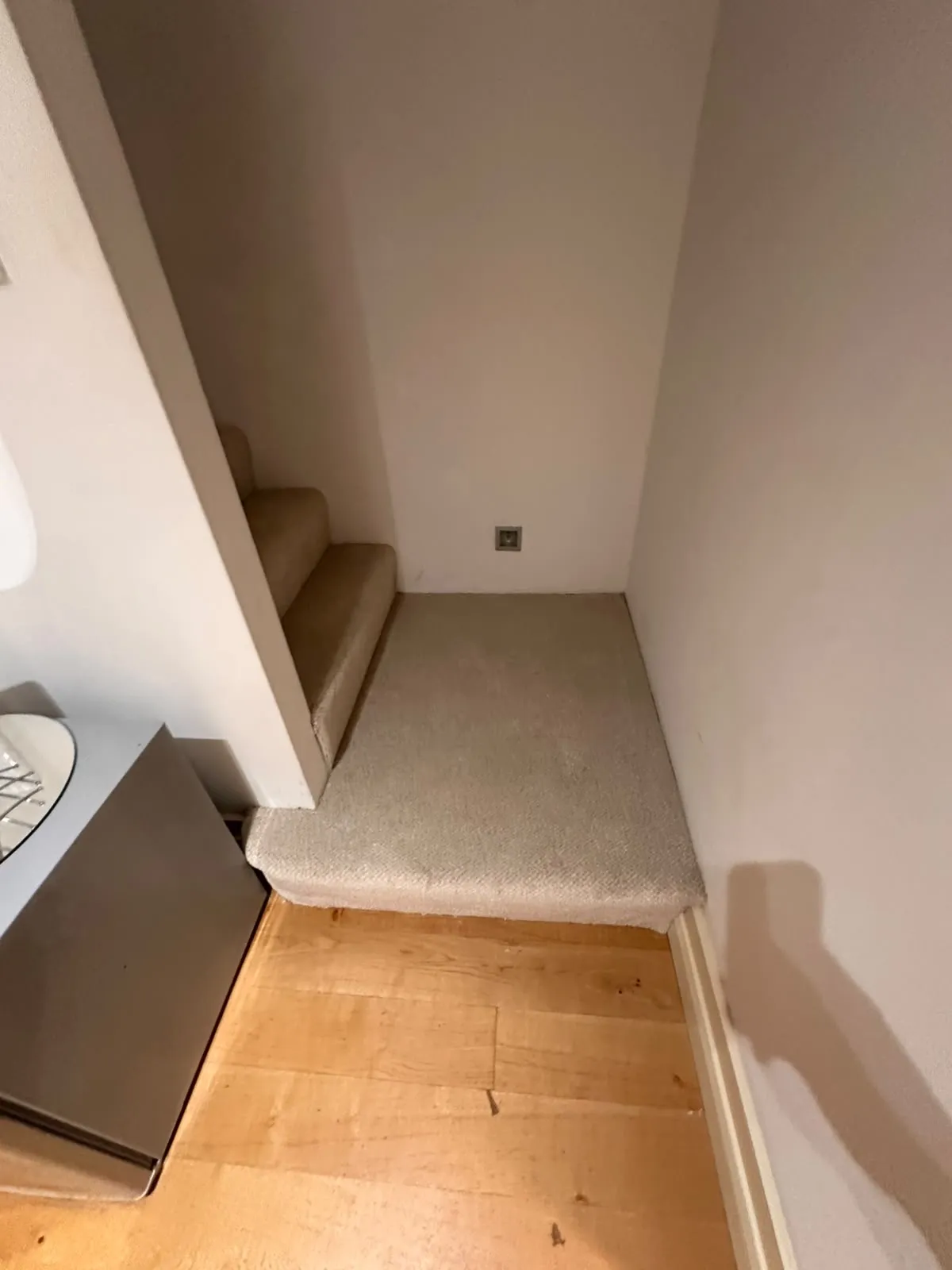 Victoria Carpets Natural Impressions carpet fitted on a stair landing meeting an oak floor, Tower Bridge, Southwark SE1