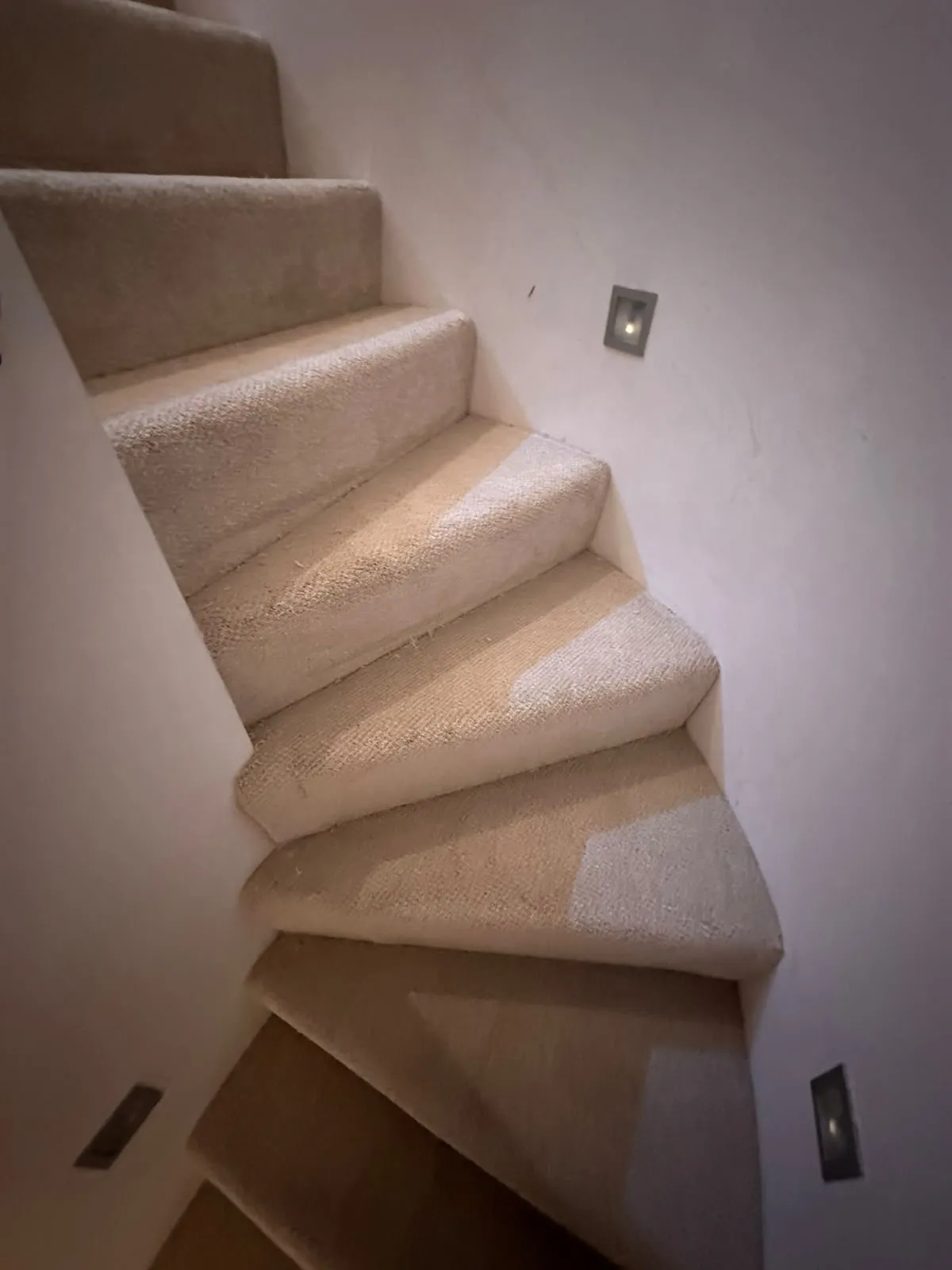 Old worn carpet on winder stairs with exposed backing before uplift and refit, Tower Bridge, Southwark SE1